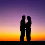 Couple Embracing on the Beach at Sunset