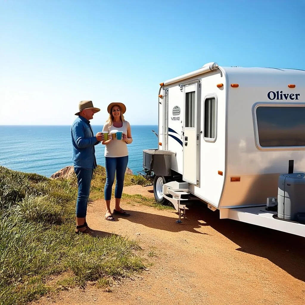 A couple standing outside their Oliver Travel Trailer, enjoying a scenic view