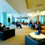 Modern hotel lobby with comfortable seating and business travelers working