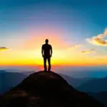 Man on Mountain Top at Sunset