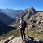 Woman Looking Out at Mountain Range