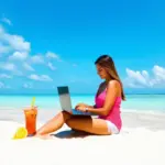 Woman using laptop on beach