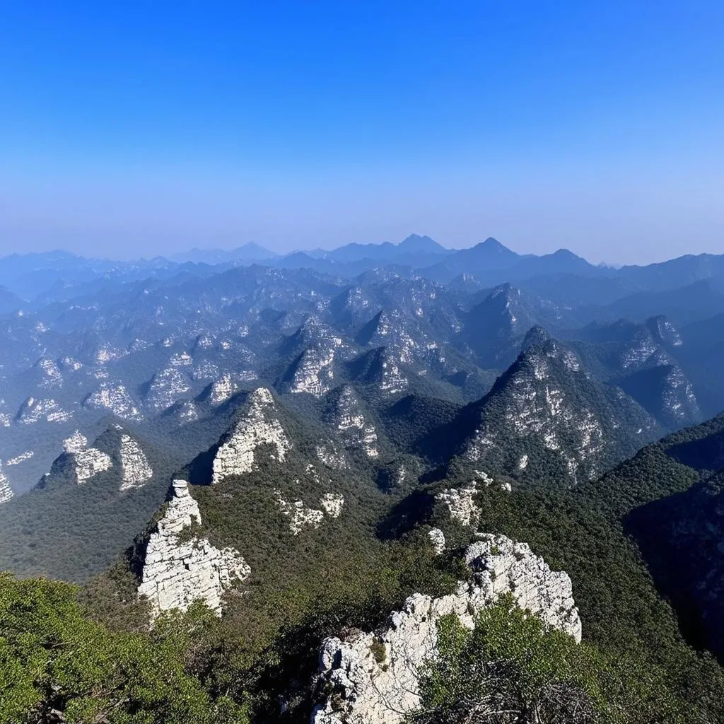 A panoramic view of mountain peaks shrouded in mist