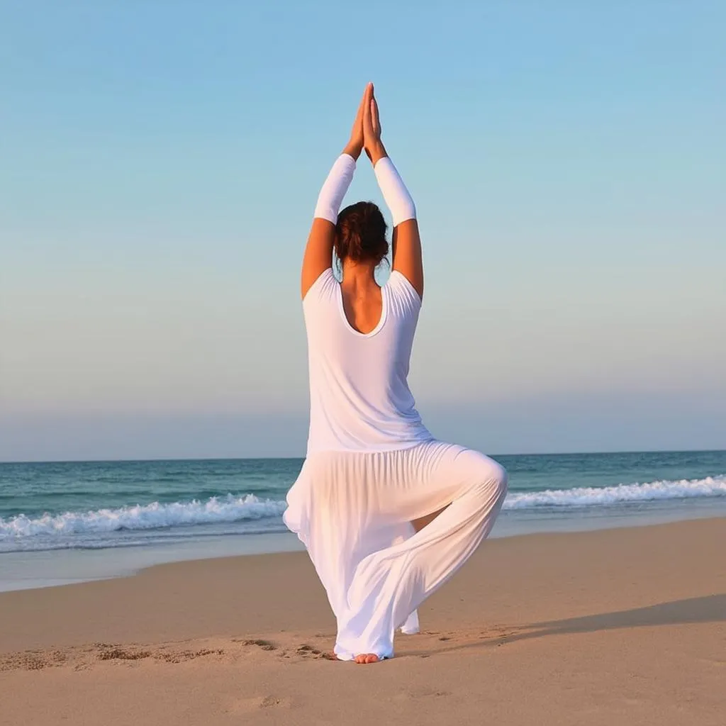 Woman practicing yoga on a serene beach