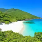 Tranquil beach scene with turquoise water and white sand