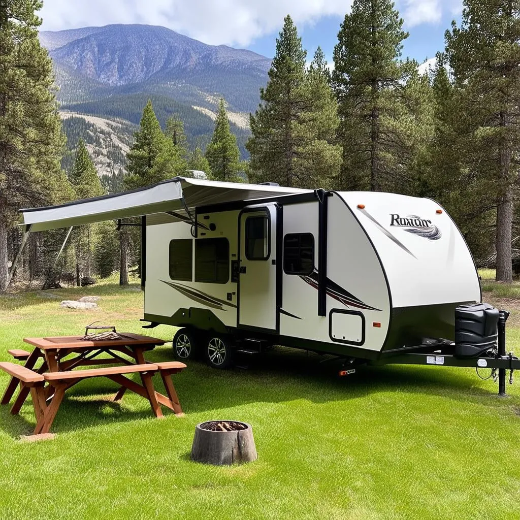 Hybrid travel trailer parked at a scenic campsite