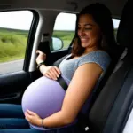 pregnant woman adjusting her seatbelt in car