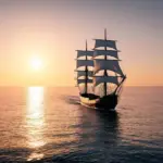 Ship sailing into the sunset on a calm ocean