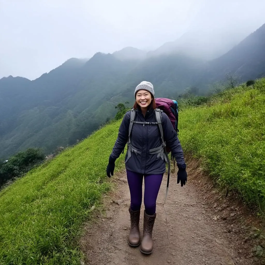 Woman in a stylish winter outfit amidst the mountainous landscape of Sapa