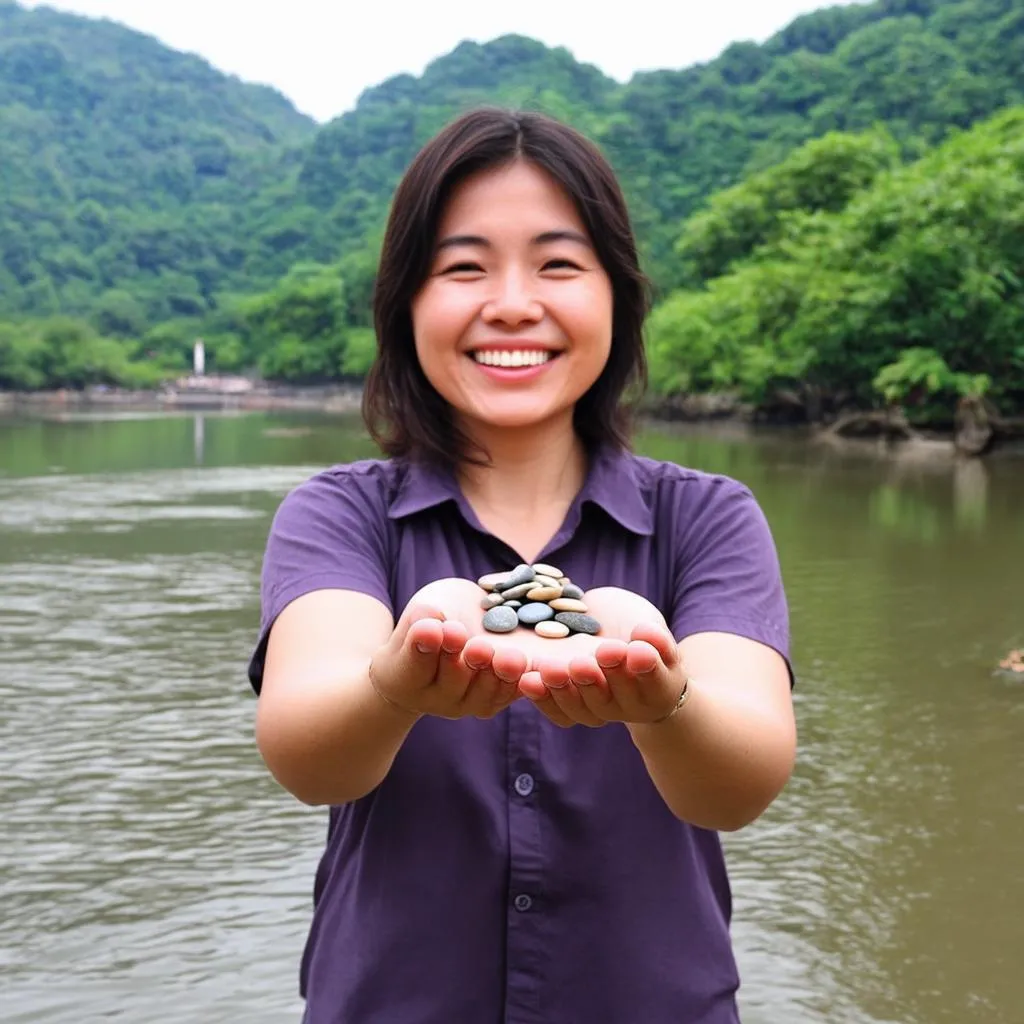 Woman holding pebbles by the river