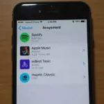 iPhone with music downloading apps displayed