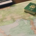 Green Card and passport on a map