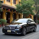 Mercedes E200 parked in front of a scenic Hanoi street