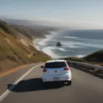 Small car driving on Pacific Coast Highway