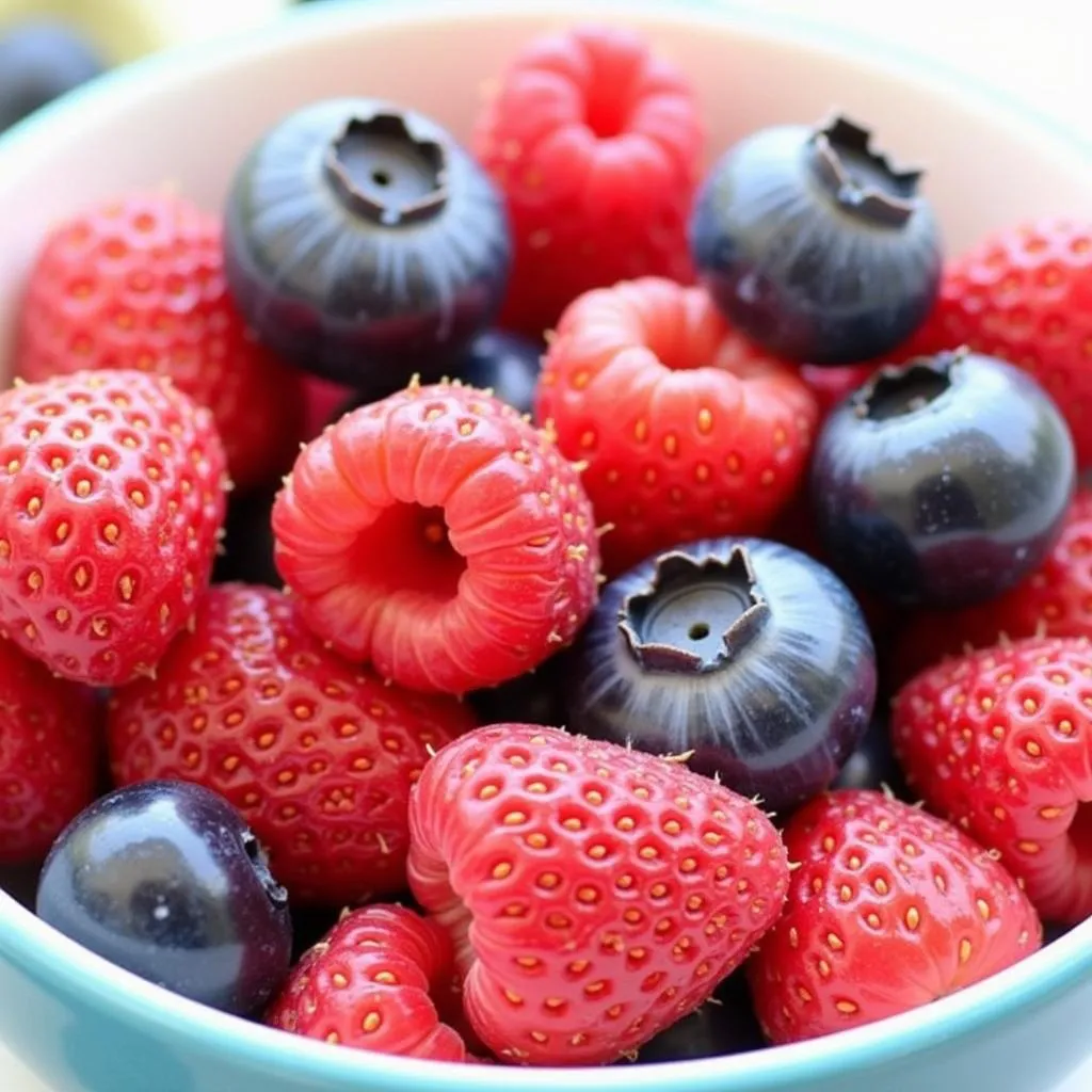 Colorful berries in a bowl, perfect for postpartum recovery