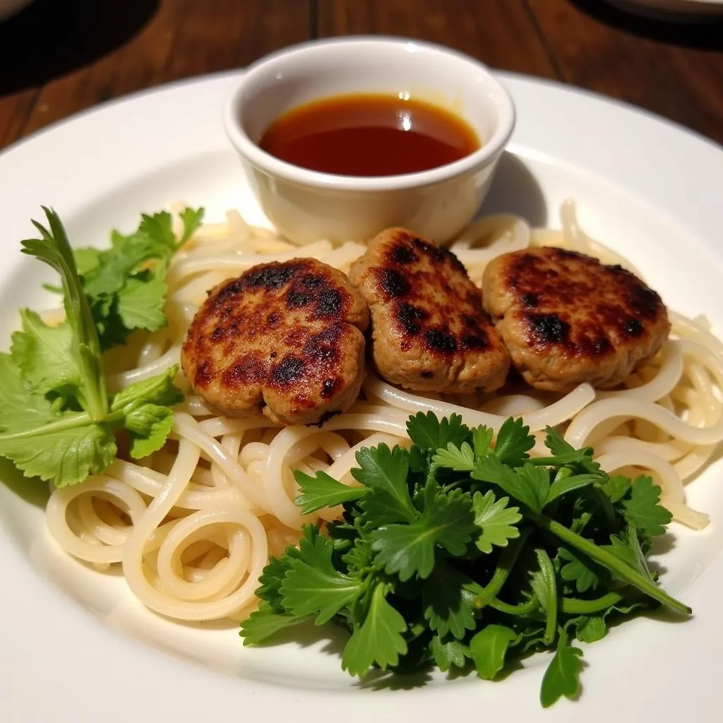 A plate of Bun Cha with fresh herbs