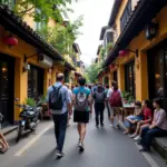 Tour guide leading tourists through Hanoi Old Quarter alleyway