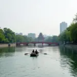 Honeymoon couple rowing a boat on Hoan Kiem Lake