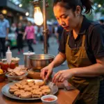 Hanoi street food vendor preparing Tu Thit