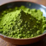 Matcha green tea powder in a bowl.