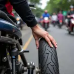 Inspecting motorbike tire pressure and condition