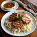 Hanoi Bun Cha for Sensitive Teeth: A plate of tender grilled pork patties and vermicelli noodles, perfect for those with toothaches.