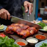 Hanoi street food vendor preparing a steaming pork knuckle dish