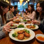 People enjoying a meal of bun cha, a Vietnamese dish of grilled pork and vermicelli noodles, in a Hanoi restaurant.