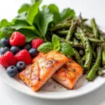 A plate of kidney-friendly foods including berries, fish, and vegetables.